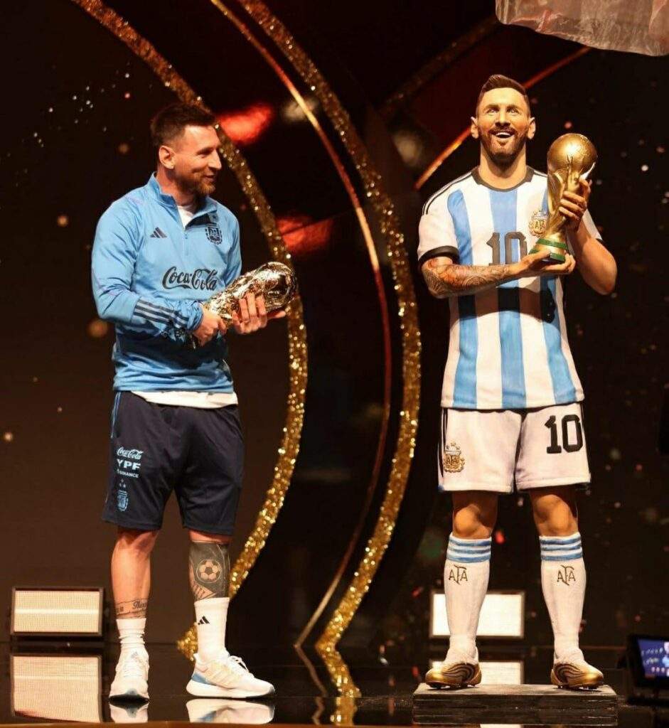 36537 messi honoured with baton of football statue