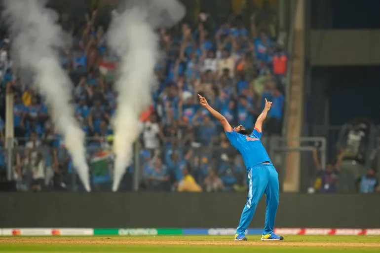Mohammed Shami celebrates the wicket of Daryl Mitchell
