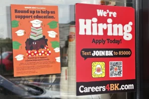 a hiring sign is displayed at a restaurant in wheeling