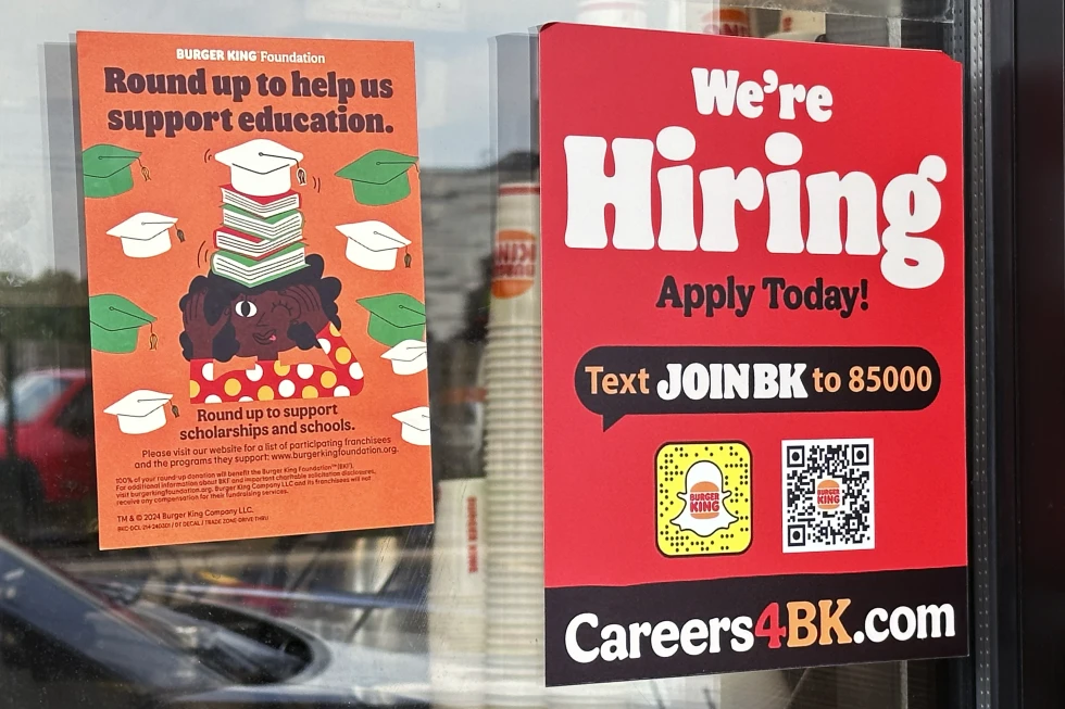 a hiring sign is displayed at a restaurant in wheeling