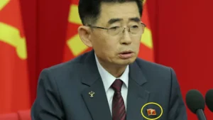 a north korean official is seen wearing a pin featuring the portrait of north korean leader kim jong un during a key meeting of the countrys ruling party in pyongyang reuters