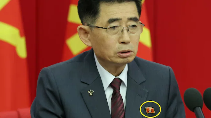 a north korean official is seen wearing a pin featuring the portrait of north korean leader kim jong un during a key meeting of the countrys ruling party in pyongyang reuters