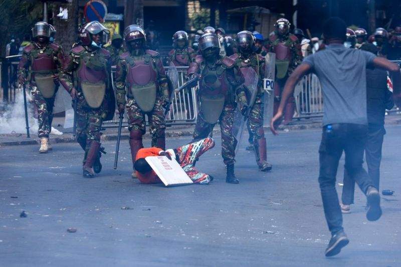 anti riot police surround a demonstrator