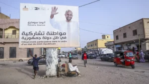 people rest under an electoral banner for presidential candidate outouma soumare ahead of the presidential candidate in nouakchott mauritania on june 25 2024