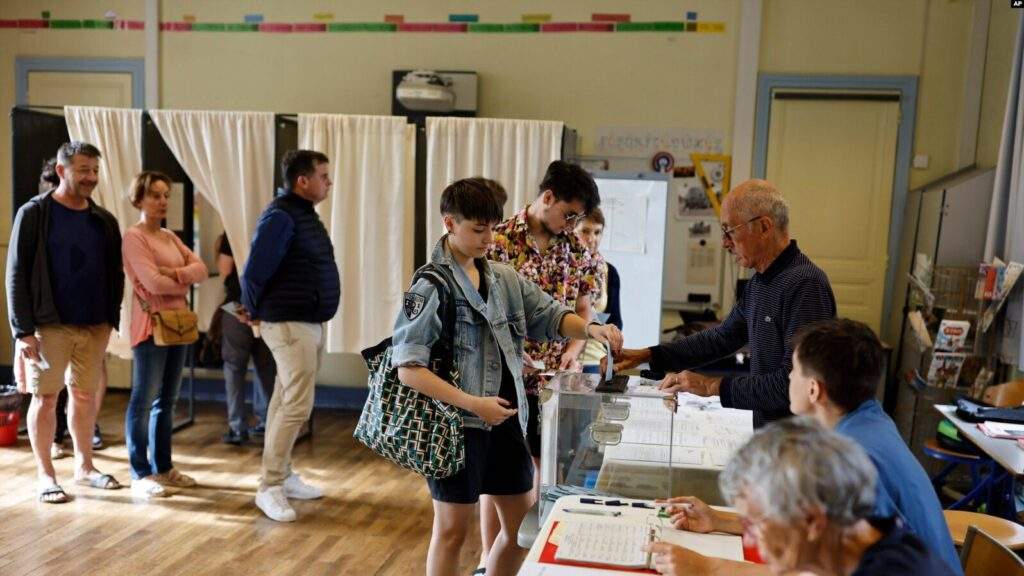 a woman casts her ballot in the second round of the legislative elections july 7 2024 in rennes western france