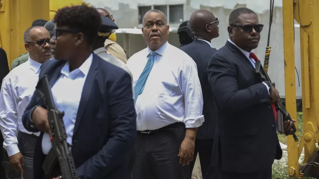 armed security officers escort haitian prime minister garry conille as he visits the general hospital in port au prince haiti tuesday july 9 2024