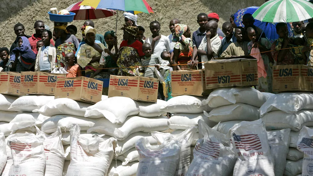 displaced people wait their turn to receive food aid from the world food program