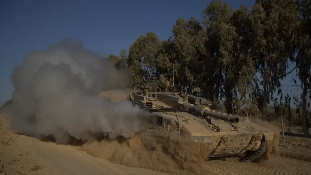 israeli soldiers move on the top of a tank near the israeli gaza border monday july 8 2024