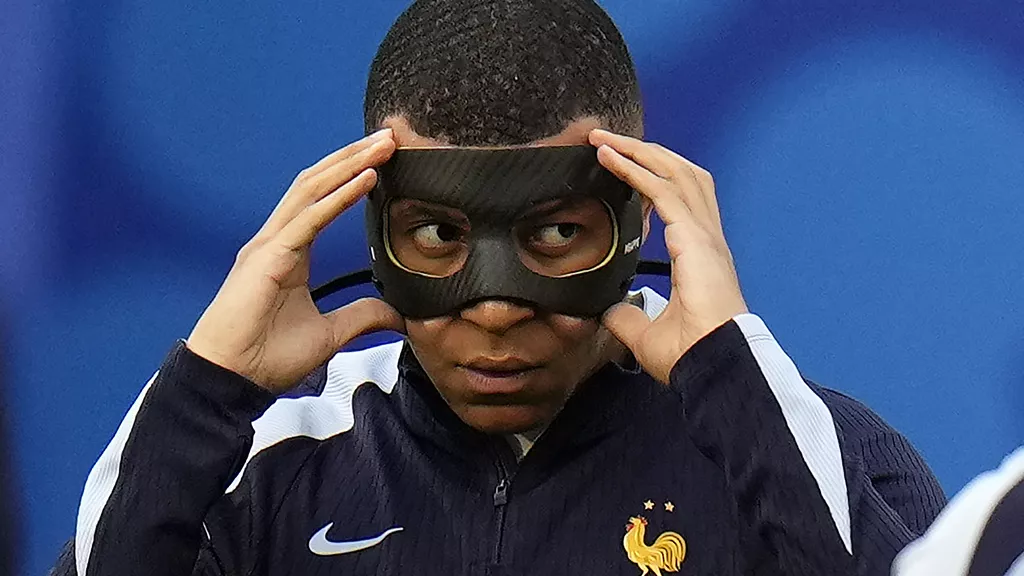 kylian mbappe of france adjusts his face mask