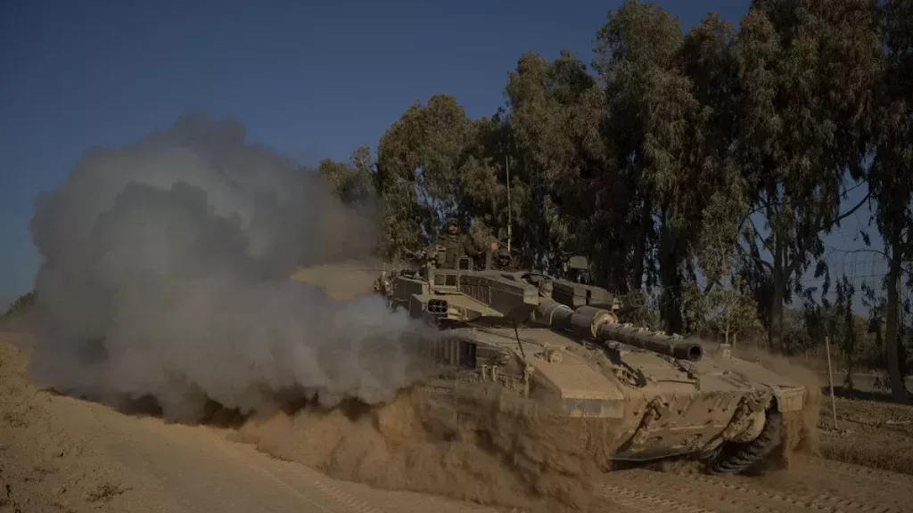 israeli soldiers move on the top of a tank near the israeli gaza border monday july 8 2024