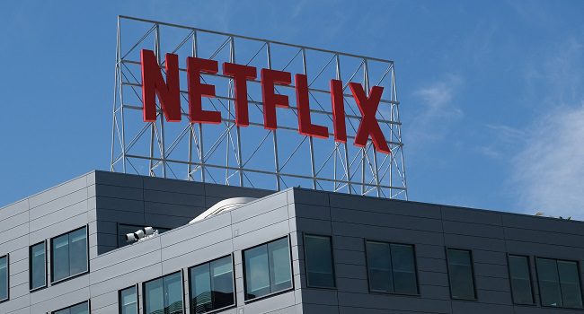 In this file photo taken on March 02, 2022, the Netflix logo is displayed on top of their office building in Hollywood, California. (Photo by Chris DELMAS / AFP)