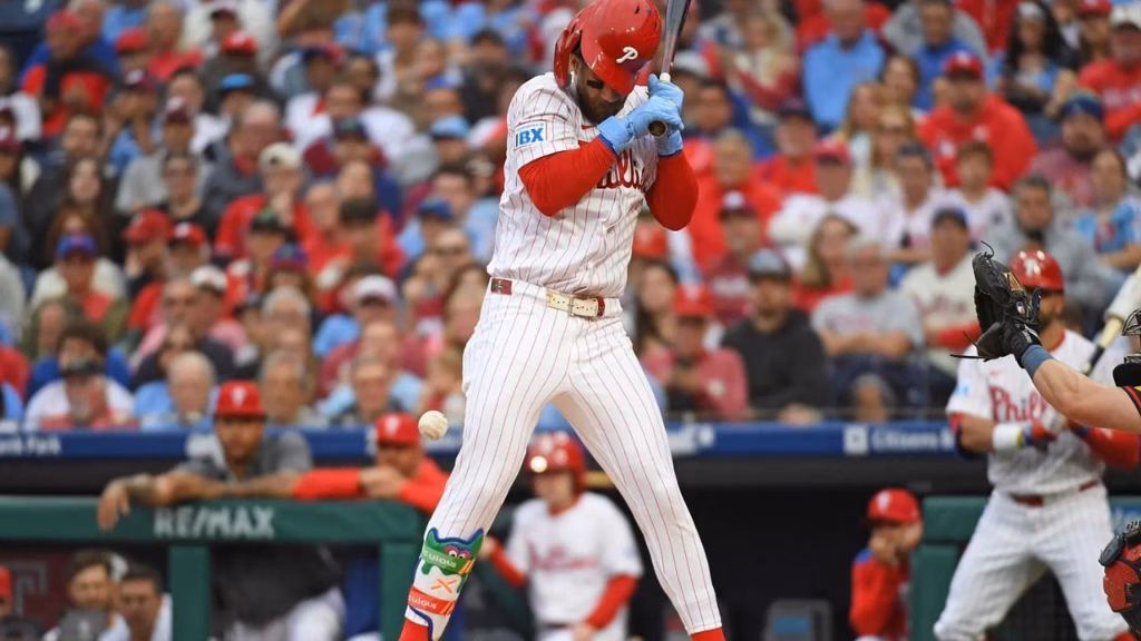 Bryce Harper reacts after getting hit (Imagn)