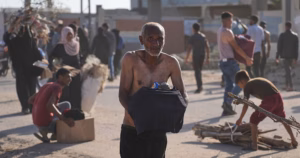 Chaos erupts as Palestinians pick up aid at a distribution center in Rafah