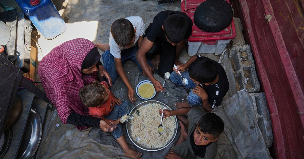Desperate Palestinians queue for food at soup kitchen during Eid al-Adha