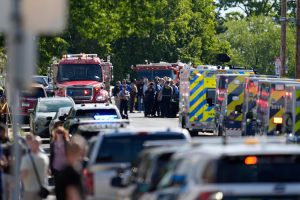 Law enforcement officers gather outside the Annunciation Church's school in response to a reported mass shooting, Aug. 27, 2025, in Minneapolis. Abbie Parr/AP