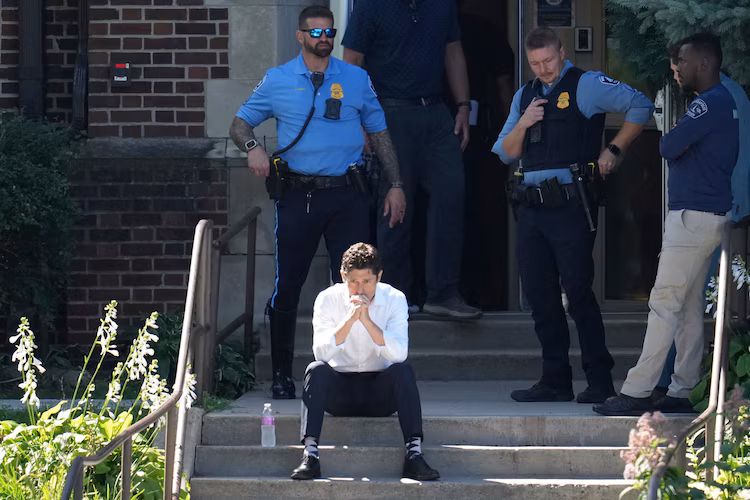 Minneapolis Mayor Jacob Frey sits on steps of the Annunciation Church's school as police response to a reported mass shooting, Aug. 27, 2025, in Minneapolis.
Abbie Parr/AP