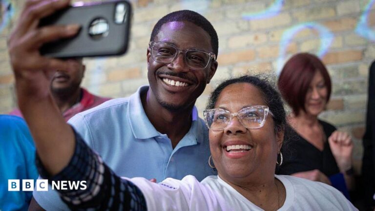 David Crowley poses for a selfie alongside a supporter while campaigning to be the Democratic candidate for Wisconsin governor