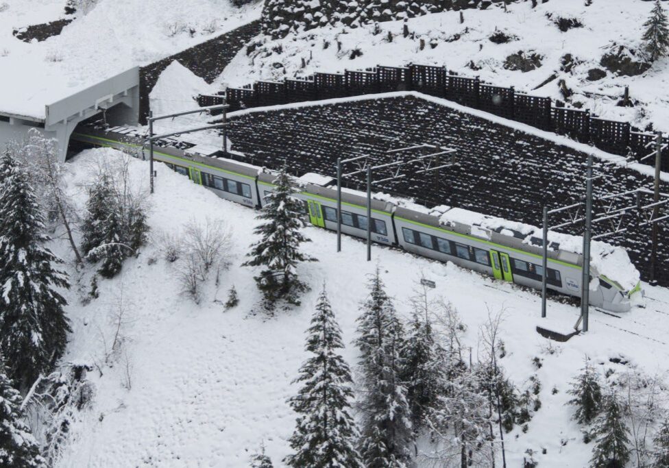 This aerial photograph shows a regional train derailed due to an avalanche in Goppenstein, southern Switzerland on February 16, 2026. (Photo by Louis DASSELBORNE / AFP)