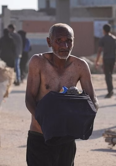Chaos erupts as Palestinians pick up aid at a distribution center in Rafah
