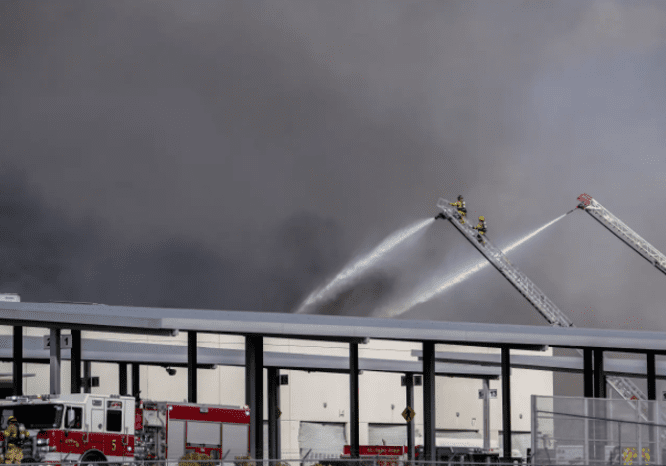 Seven injured as firefighters battle inferno after explosion near US airport