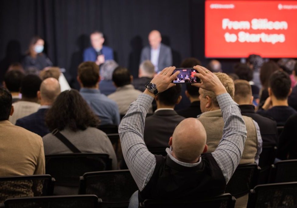 An attendee at a StrictlyVC 2025 event taking a photograph