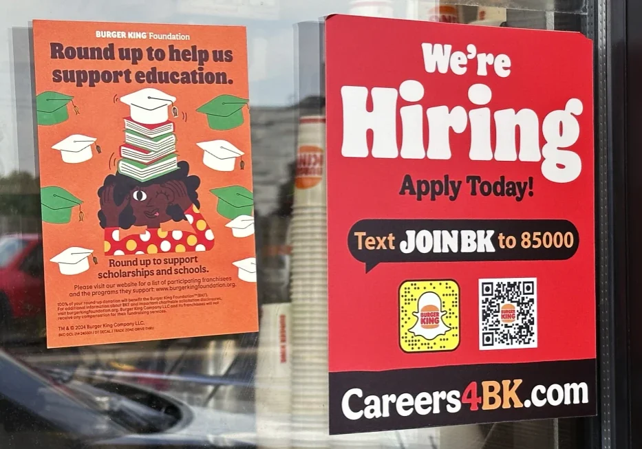a hiring sign is displayed at a restaurant in wheeling
