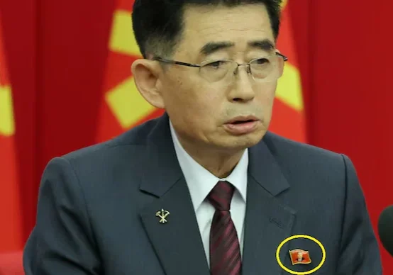 a north korean official is seen wearing a pin featuring the portrait of north korean leader kim jong un during a key meeting of the countrys ruling party in pyongyang reuters a north korean official is seen wearing a pin featuring the portrait of north korean leader kim jong un during a key meeting of the countrys ruling party in pyongyang reuters