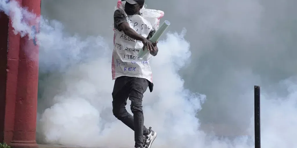 a protester returns back a teargas canister to kenya police in nairobi kenya thursday june 27 2024