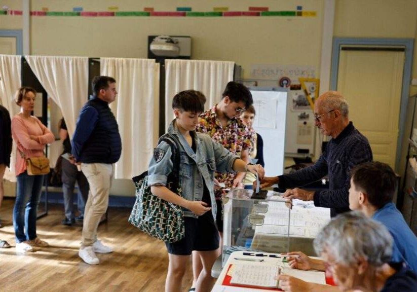a woman casts her ballot in the second round of the legislative elections july 7 2024 in rennes western france a woman casts her ballot in the second round of the legislative elections july 7 2024 in rennes western france
