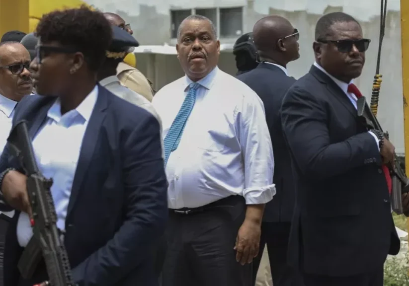 armed security officers escort haitian prime minister garry conille as he visits the general hospital in port au prince haiti tuesday july 9 2024
