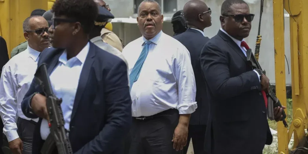 armed security officers escort haitian prime minister garry conille as he visits the general hospital in port au prince haiti tuesday july 9 2024 armed security officers escort haitian prime minister garry conille as he visits the general hospital in port au prince haiti tuesday july 9 2024