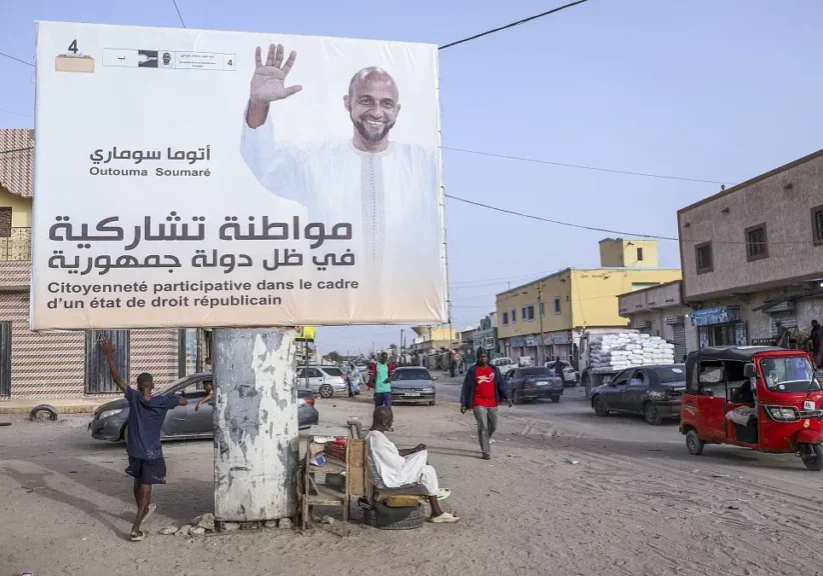 people rest under an electoral banner for presidential candidate outouma soumare ahead of the presidential candidate in nouakchott mauritania on june 25 2024 people rest under an electoral banner for presidential candidate outouma soumare ahead of the presidential candidate in nouakchott mauritania on june 25 2024