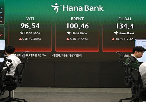 Currency dealers monitor exchange rates as an electronic screen shows the prices of WTI (L), Brent crude (C) and Dubai crude (R) in a foreign exchange dealing room at the Hana Bank headquarters in Seoul on March 13, 2026. (Photo by Jung Yeon-je / AFP)